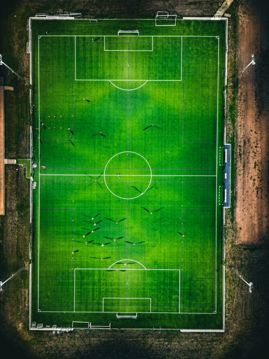 Football match action on a green pitch under stadium lights